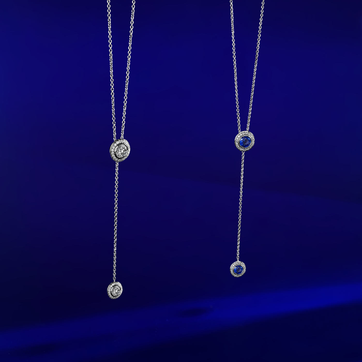 Royal Harmony Lariat Pendant With 2 Diamonds set pave all around designed by carati jewelry in montreal canada 14 k 18k in blue bacround with sapphire pendant
