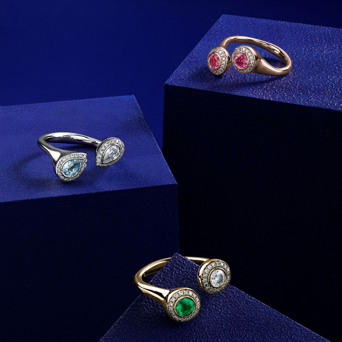 Toi et moi with two round centers in emerald and diamond with pave set all around designed by carati jewelry in montreal canada in 18 k 14 k in blue backround 3 rings