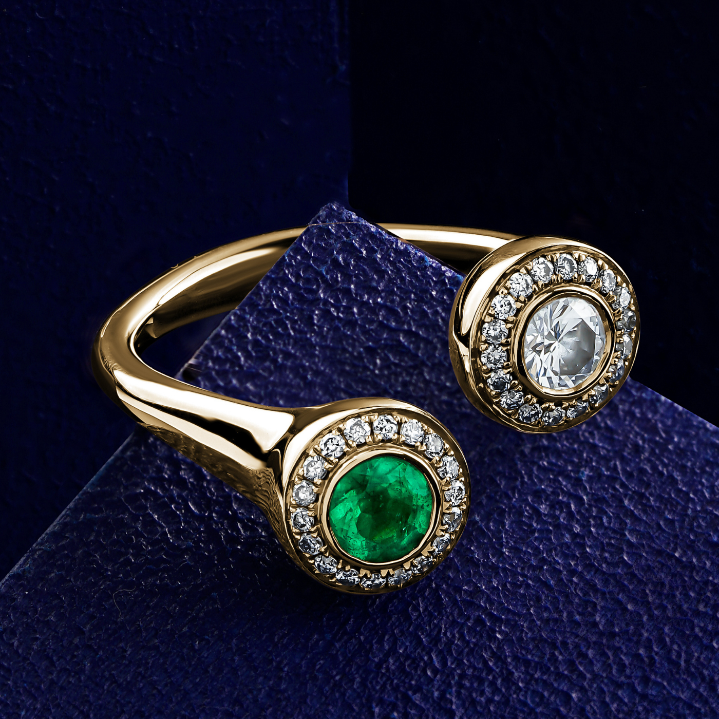 Toi et moi with two round centers in emerald and diamond with pave set all around designed by carati jewelry in montreal canada in 18 k 14 k in bue backround