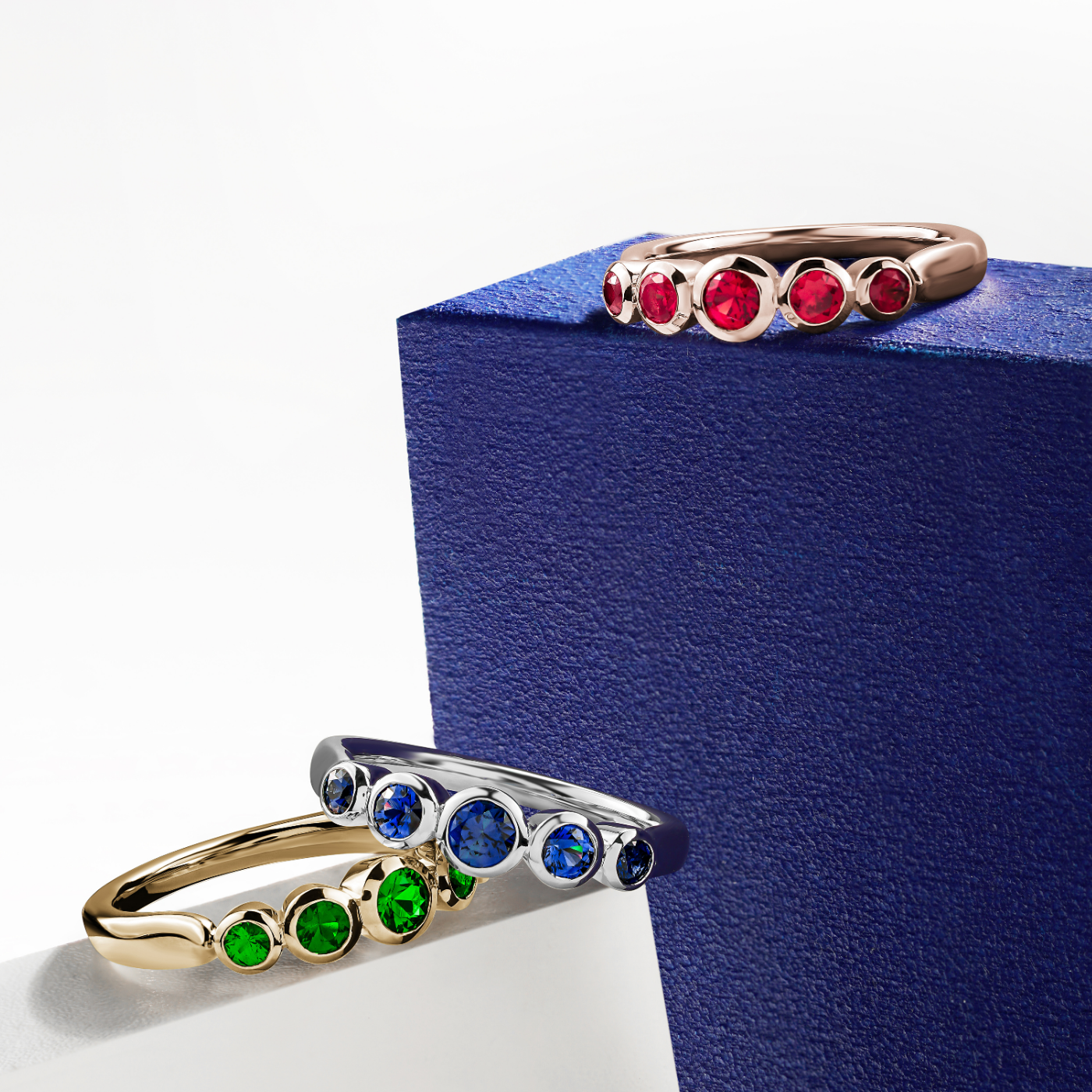Aria ring with 5 bezels set in Tsavorites designed by carati jewelry montreal canada 18k 14 k with white and blue backround and all 3 rings