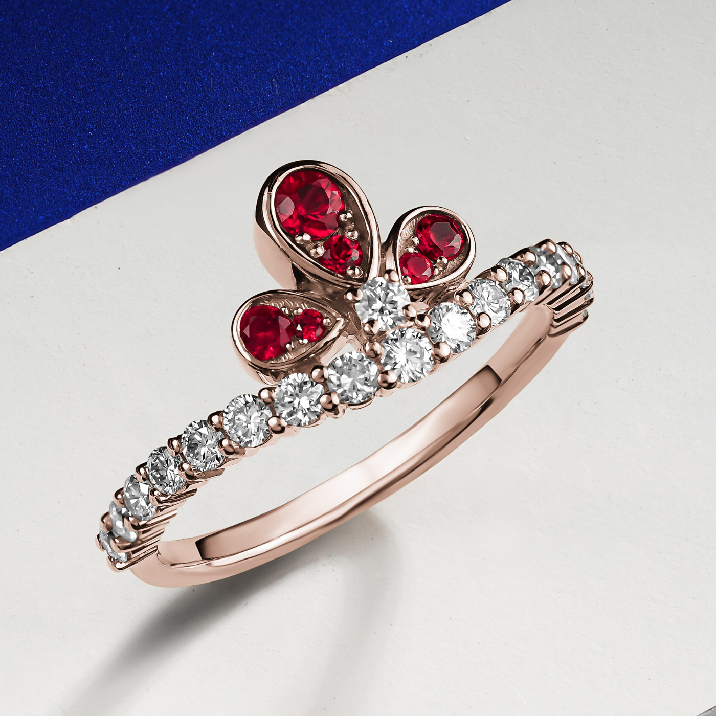 Bloom ring set with a rubys and diamonds going half way designined by carati jewelry montreal canada 18 k 14 k in blue and white backround zoom