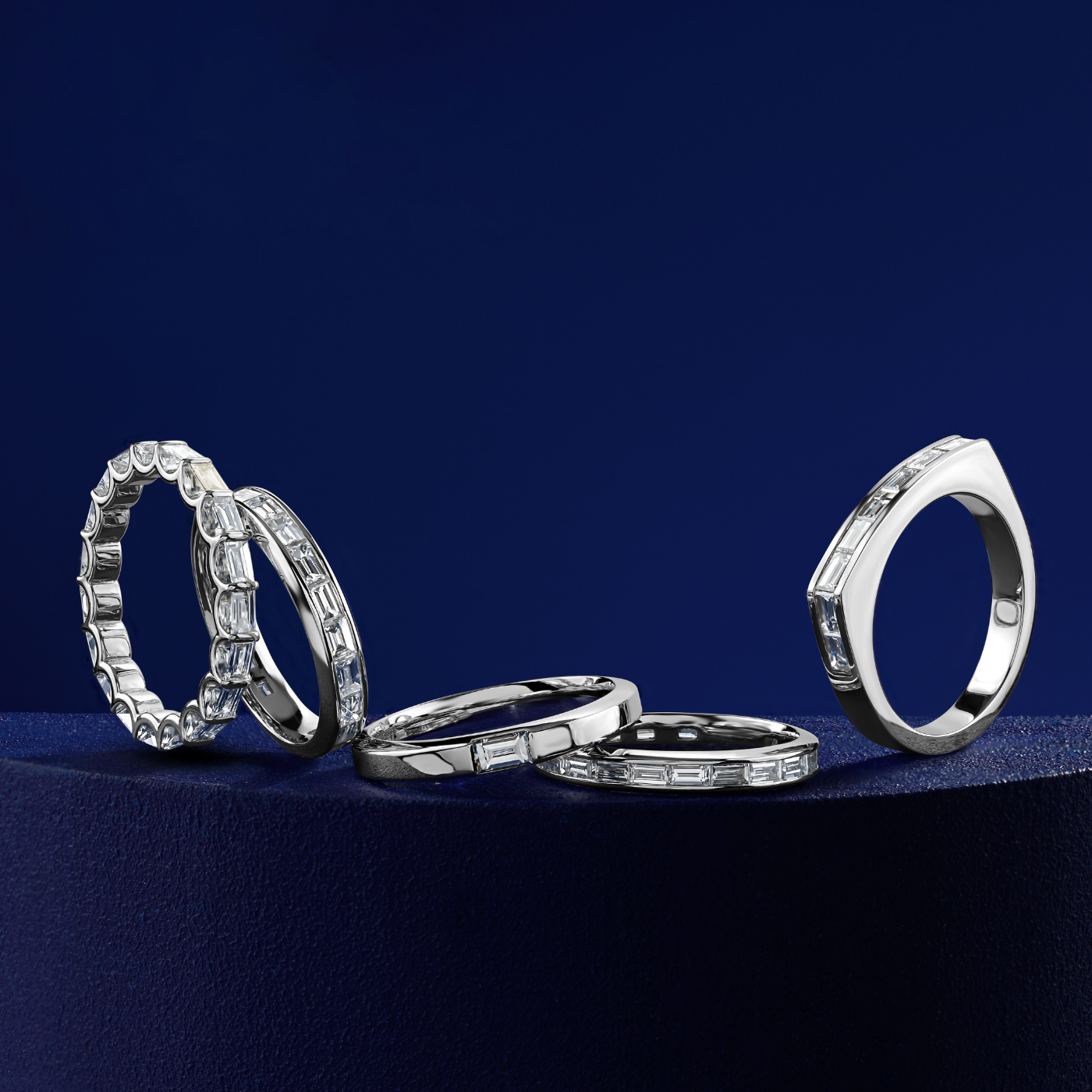 Triumph full eternity ring set with baquettes in a arc design,designed by carati jewelry montreal canada 18 k 14 k in blue backround and all the wedding bands