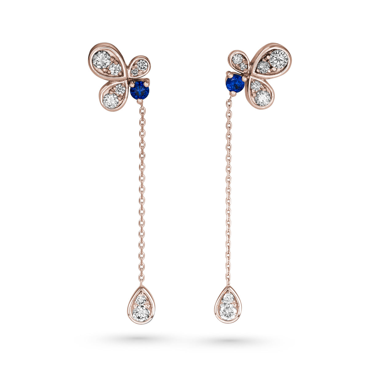 Bloom pair of earrings featuring royal blue sapphires with butterfly designs, connected to diamond-studded chains designed by carati jewelry in montreal canada in 18 k 14 k