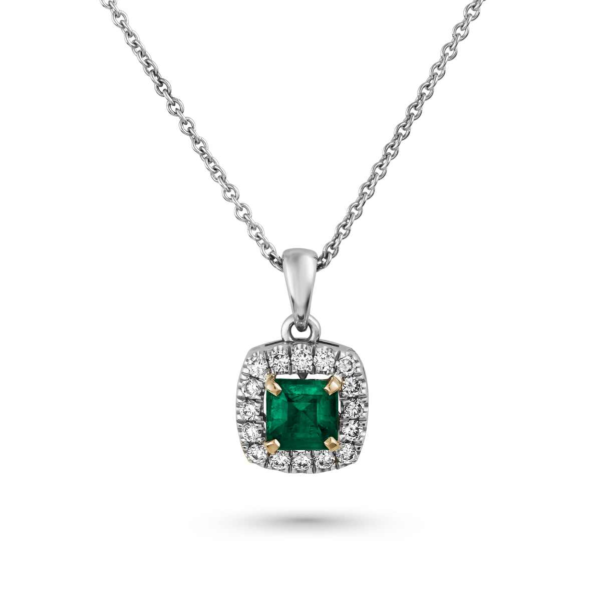 An elegant square pendant necklace with a central emerald surrounded by pave diamonds in sophisticated spark designed by carati jewelry in montreal canada in 18 k 14 k