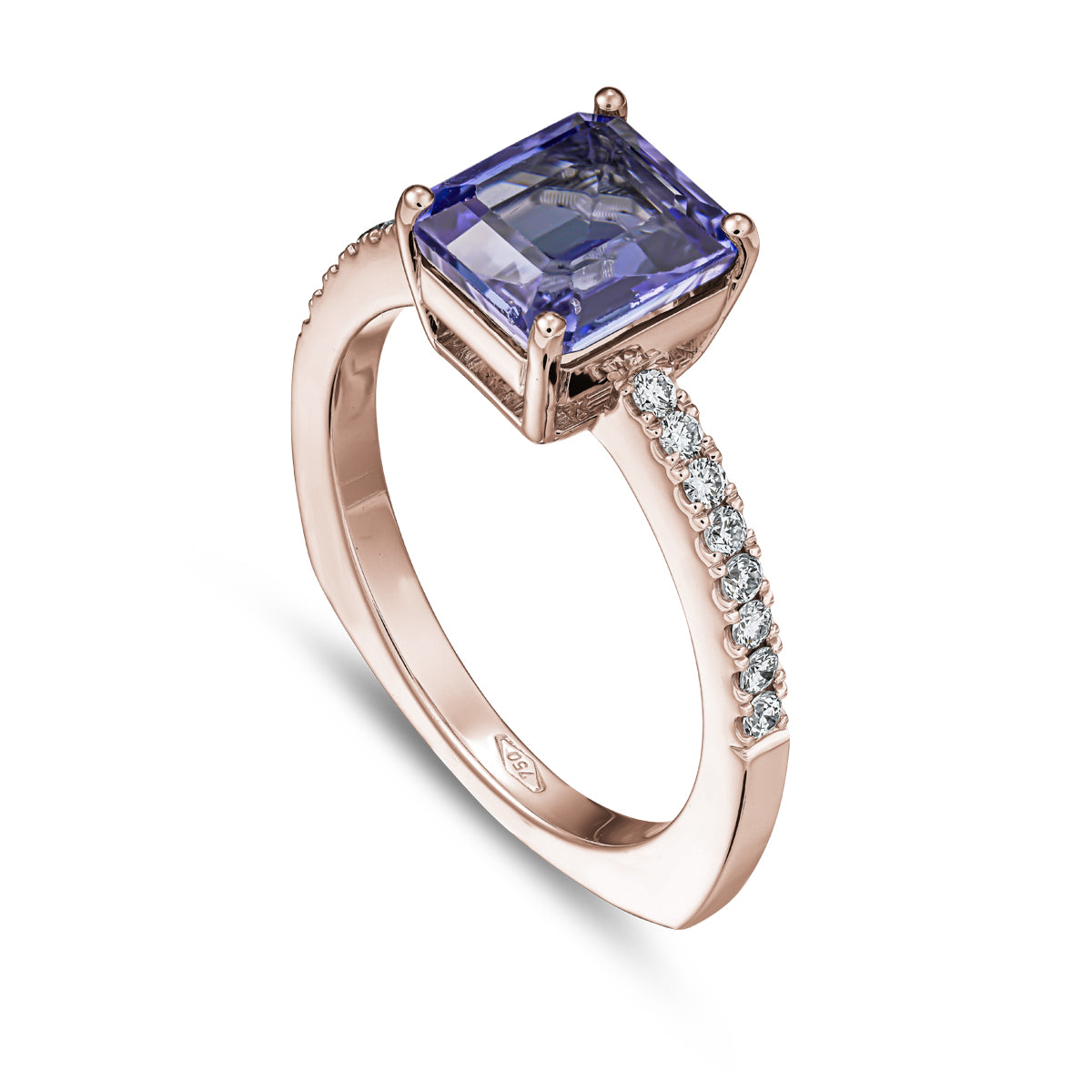 A squarish tanzanite ring with diamonds on the shank, set in white gold designed by carati jewelry in montreal canada in 18 k 14 k