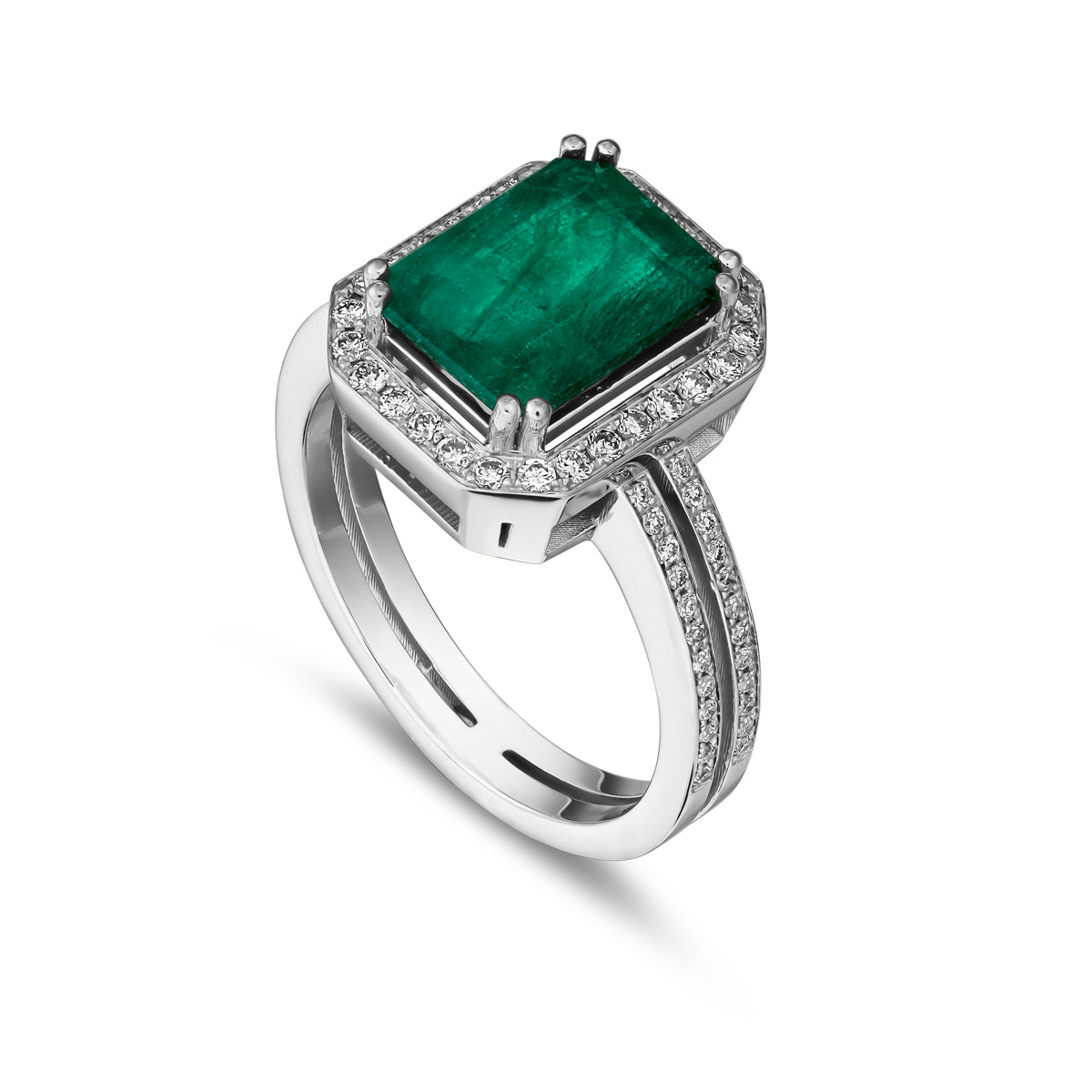 An emerald cut diamond engagement ring with parallel shank and smaller diamonds around it, set in a likely white gold or platinum band designed ny carati jewelry in 14 k 18 k