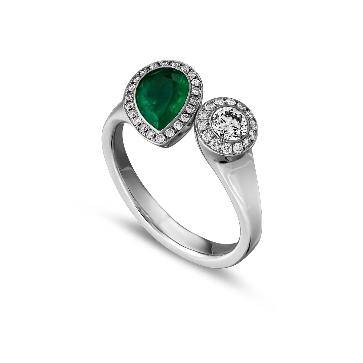 Toi et moi ring featuring a pear-shaped emerald and a smaller round diamond surrounded by a halo of smaller diamond accents designed by carati jewelry in montreal canada in 18 k 14 k diamonds.