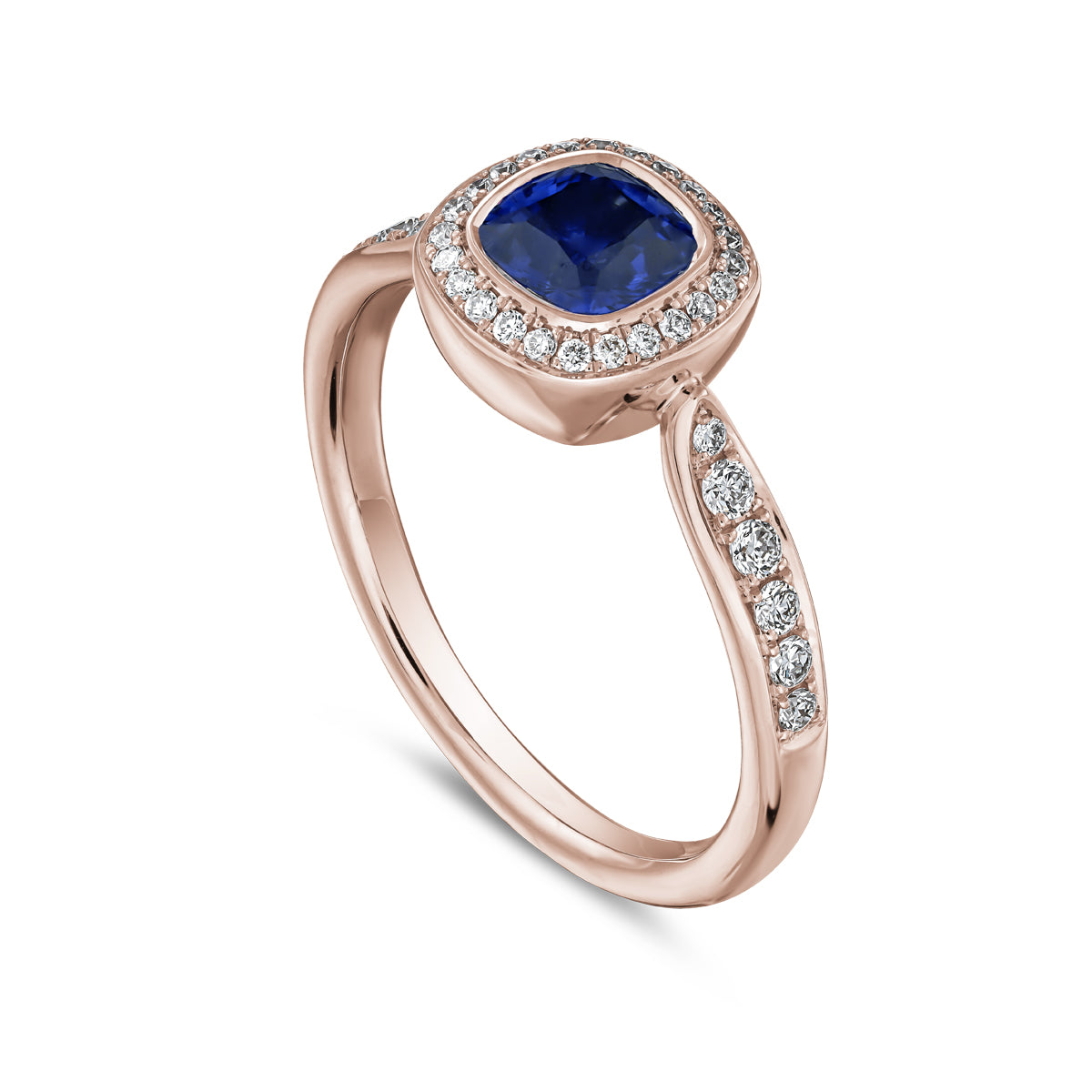 Royal harmony ring with royal blue sapphire cushion surrounded by pave diamonds and on the shank designed by carati jewelry in montreal canada 14k 18 k