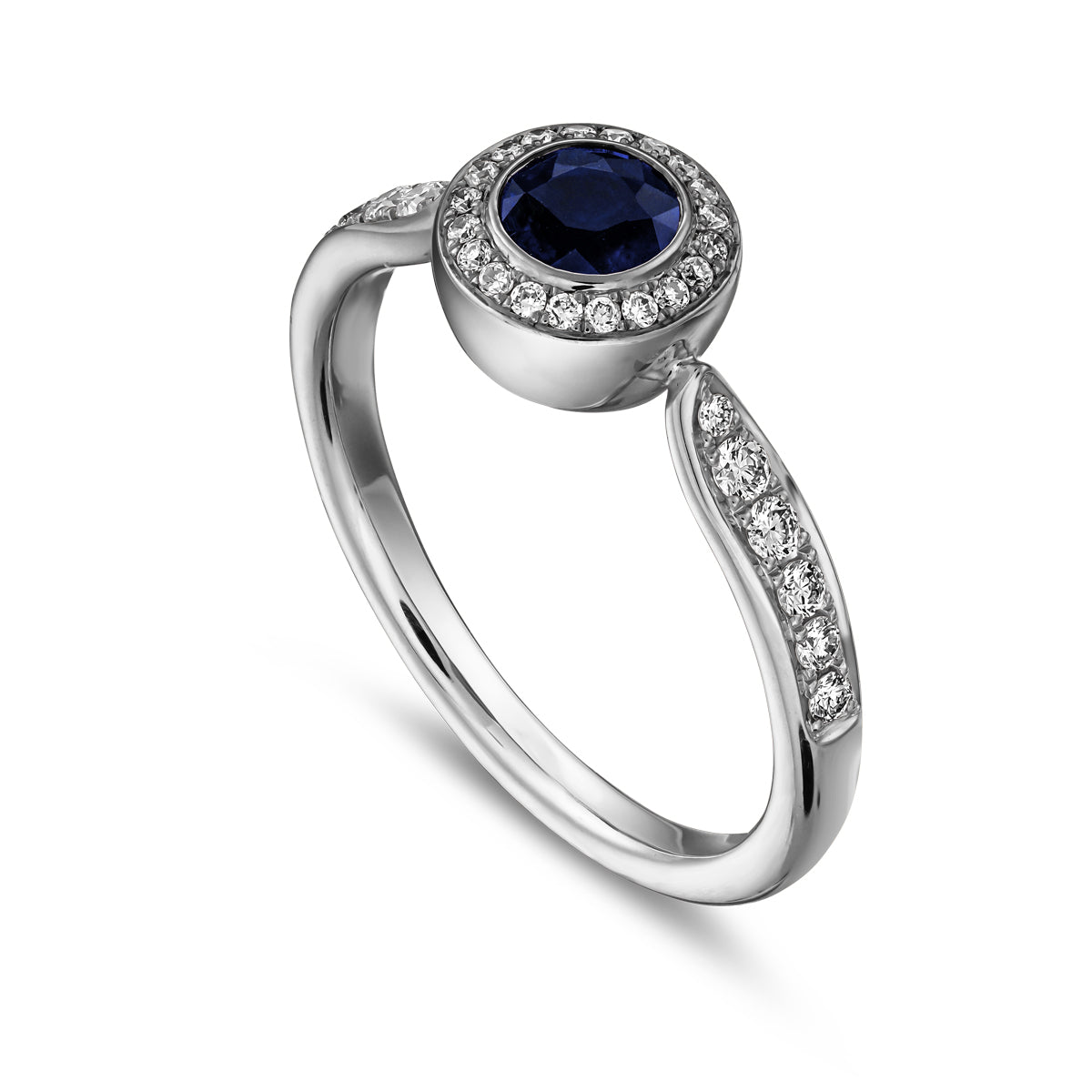 Royal harmony ring with round royal blue sapphireb surrounded by pave diamonds and on the shank designed by carati jewelry in montreal canada 18k 14 k
