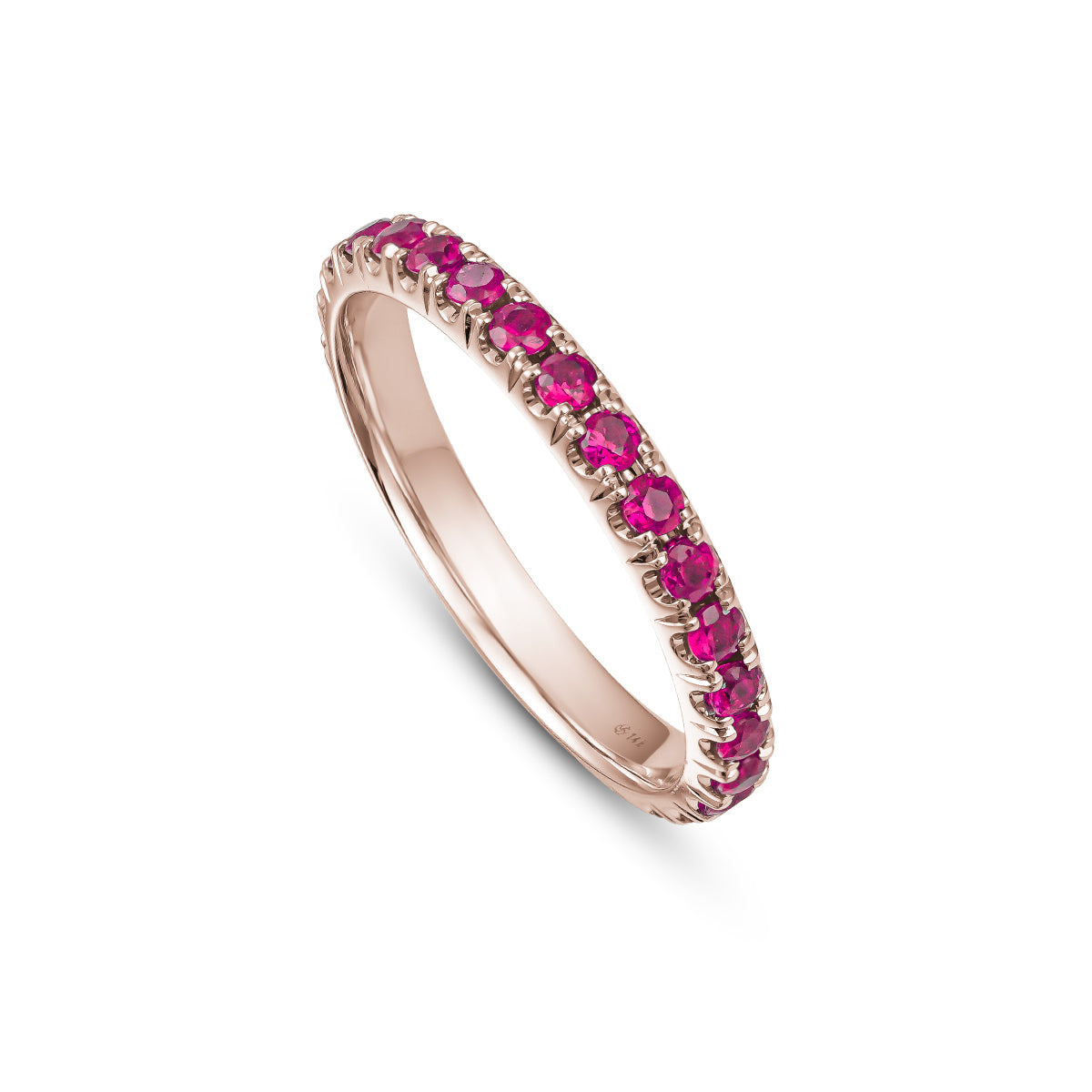 A gold engagement ring set with pigeon blood ruby stones, featuring intricate hand-engraved details.