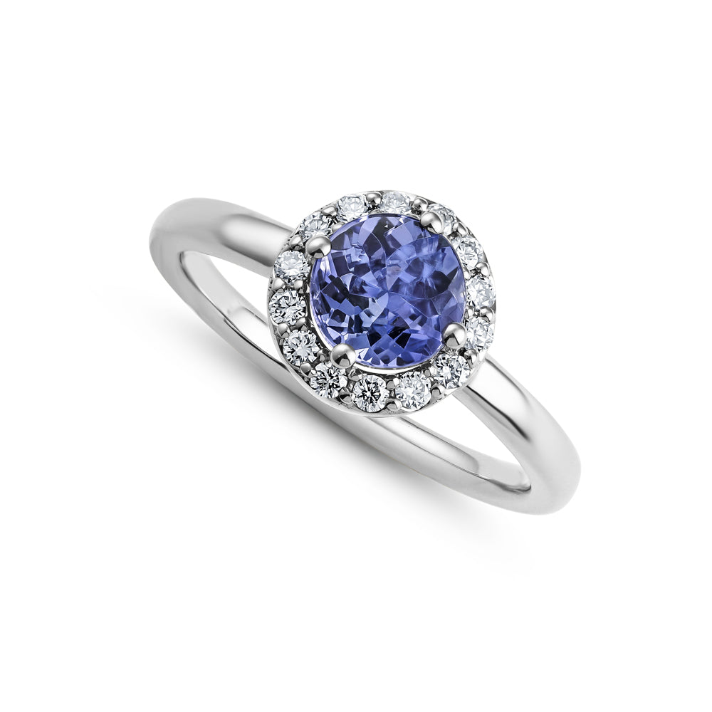 14k and 18 k white gold round tanzanite in center with diamond halo aroud it Carati Jewelry Montreal