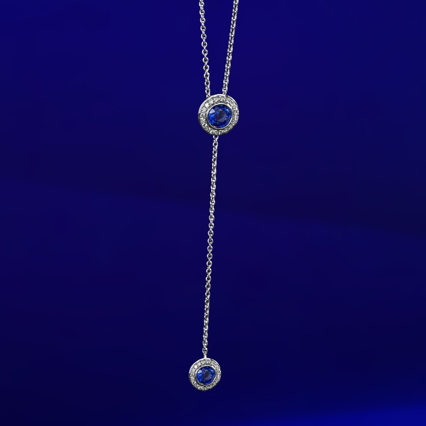 Royal Harmony Lariat Pendant With 2 Royal blue sapphires set pave all around designed by carati jewelry in montreal canada 14 k 18k in zoom and blue backround
