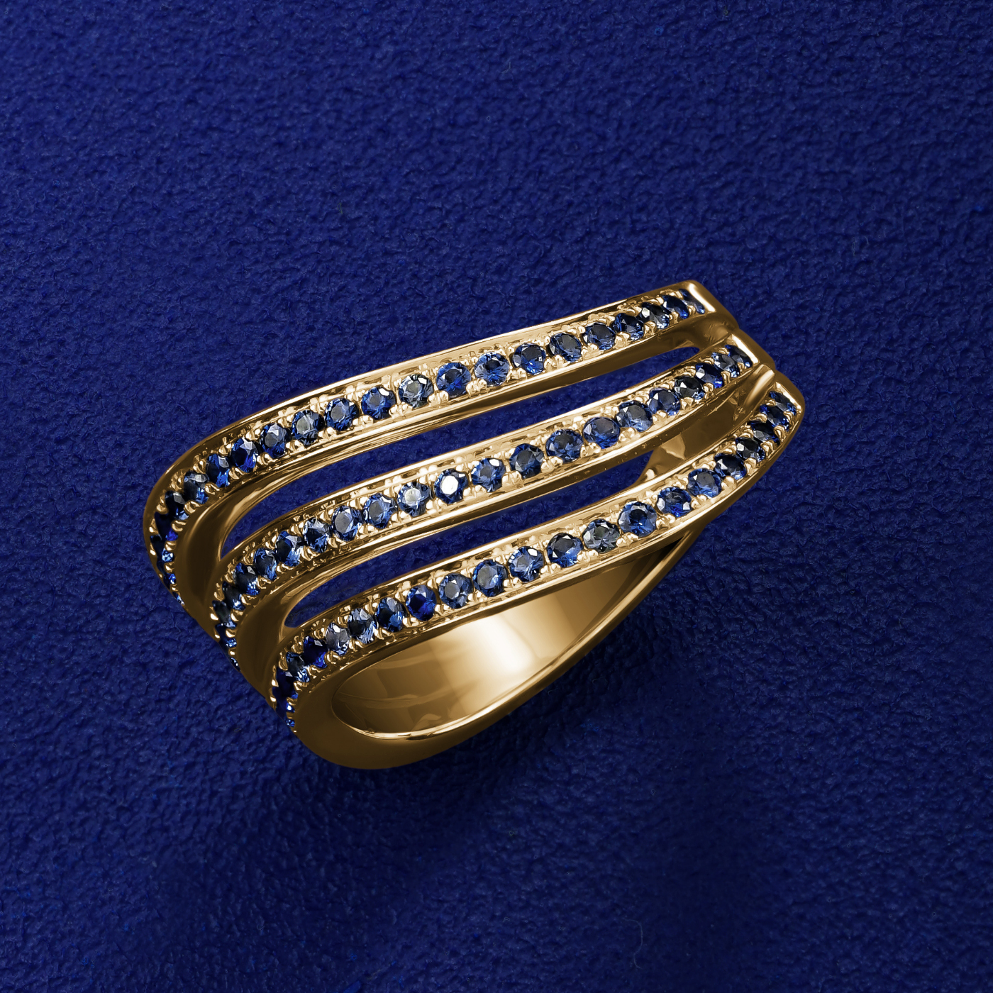 Triple Wavy Ring with a royal blue sapphires set in pave , iconic design by carati jewelry in montreal canada in 18k 14k in blue backround and zoomed