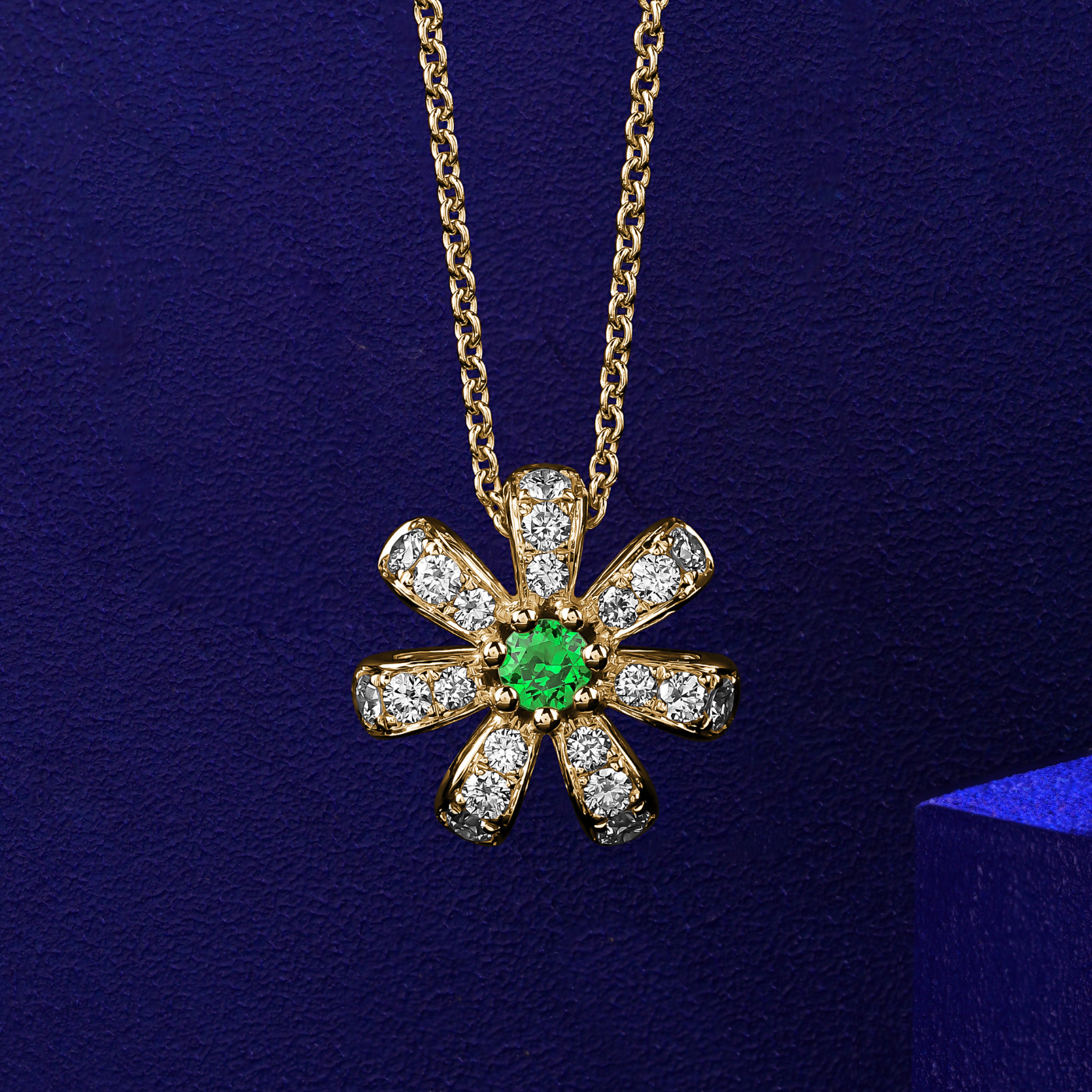 Fiora pendant set in pave diamonds  a Sparkling tsavorite in the middle is iconic design from carati jewelry in montreal canada in 18k 14 k in blue backround in zoomed