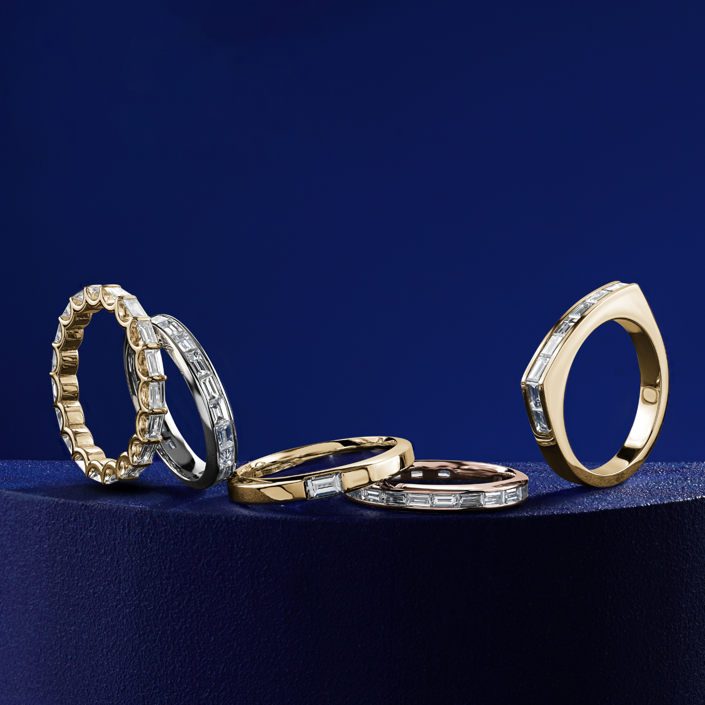 Triumph full eternity ring set with baquettes  in a arc design,designed by carati jewelry montreal canada 18 k 14 k in blue backround and all colors of different wedding bands