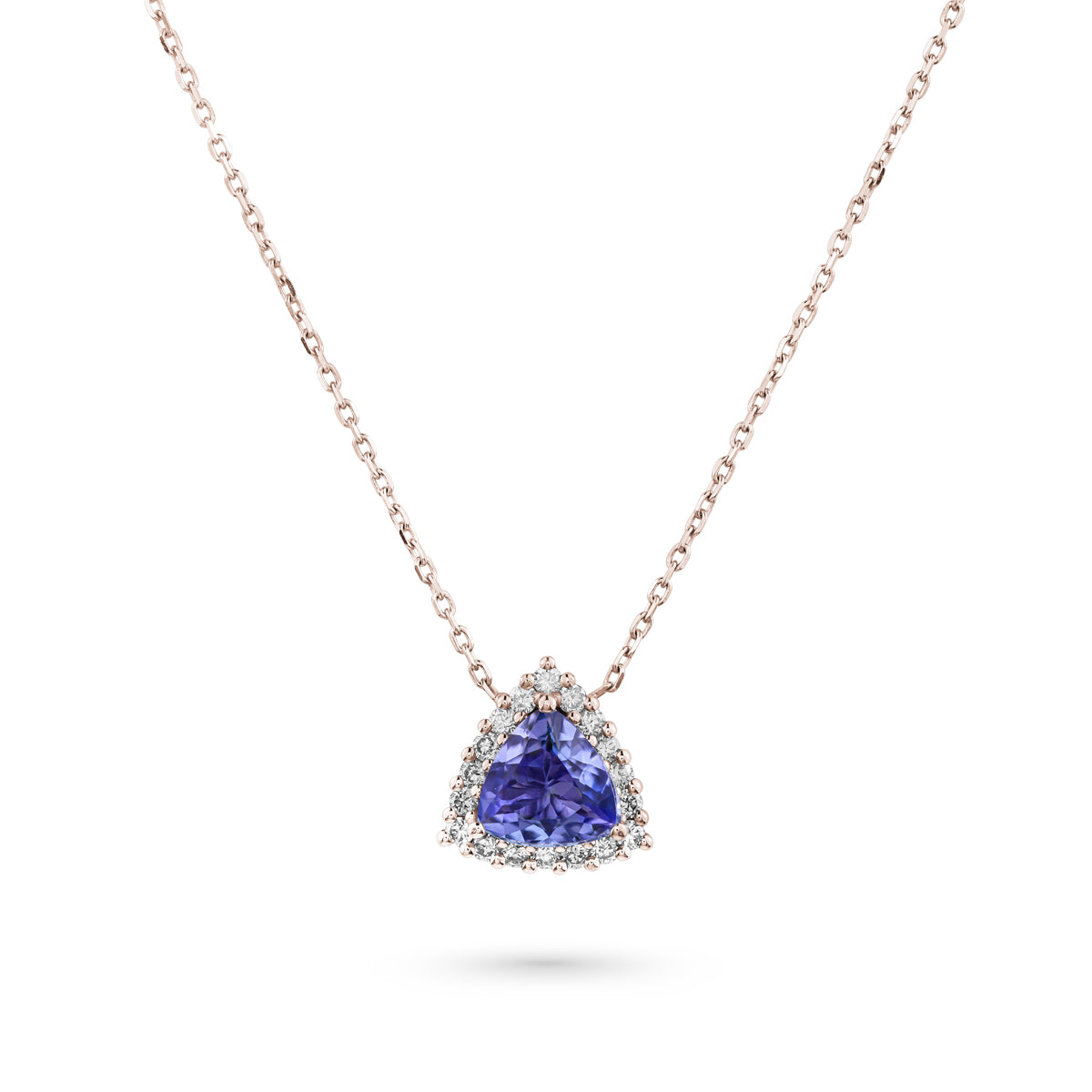A trillion-shaped tanzanite pendant surrounded by a halo of sparkling diamonds, suspended from a chain designed by carati jewelry montreal canada in 18 k 14 k pendants 