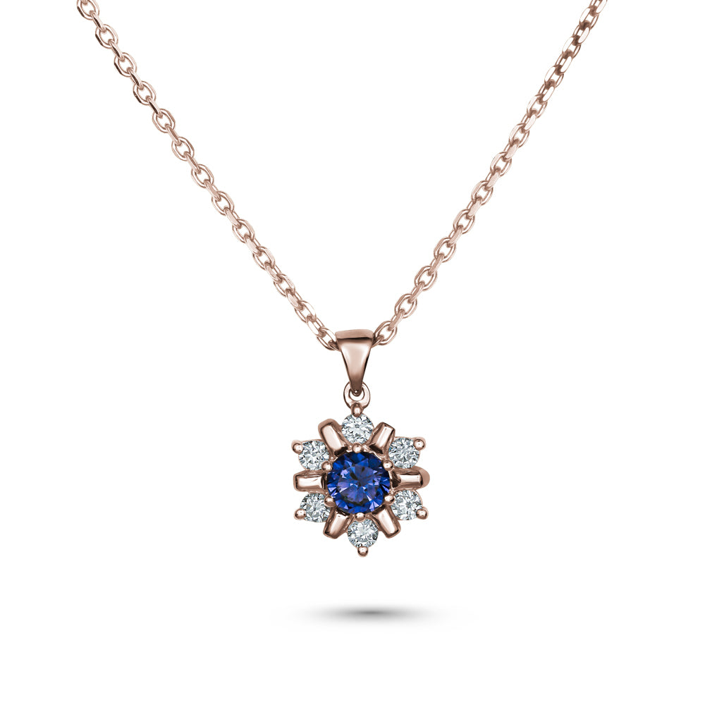 18k rose gold snowflake pendant with blue sapphire in the middle and  set around  in diamonds carati jewelry montreal