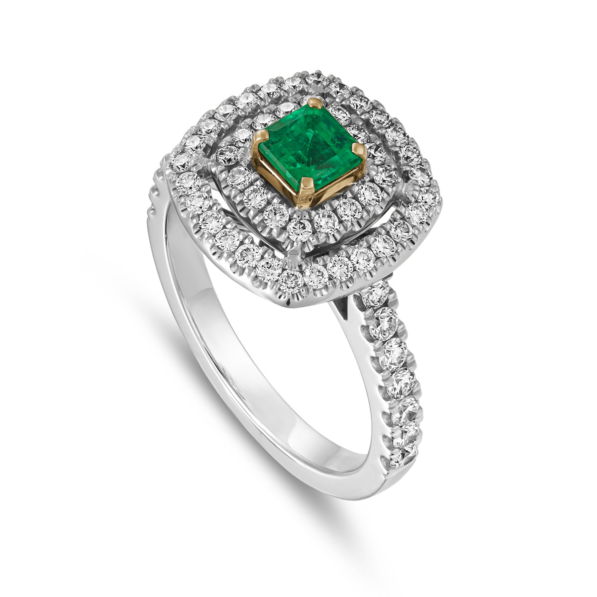 A square emerald set in two tone in a double halo ring with a setted shank designed by carati jewelry in 14k 18 k in vs diamonds