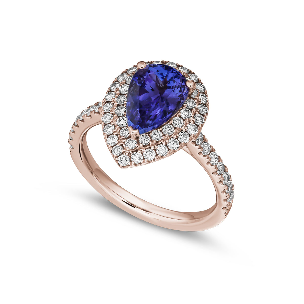 A two row two tone halo ring centered with a pear-shaped tanzanite stone and surrounded by smaller diamonds set in a silver or white gold band from carati jewelry montreal canada