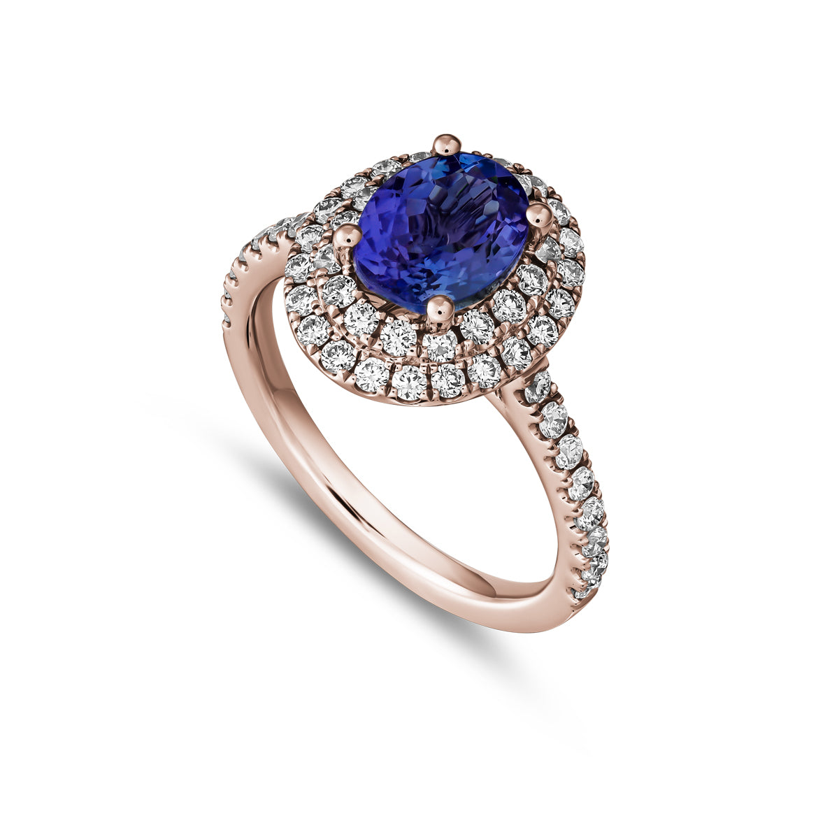 A two row two tone halo ring centered with a oval-shaped tanzanite stone and surrounded by smaller diamonds set in a silver or white gold band from carati jewelry montreal canada