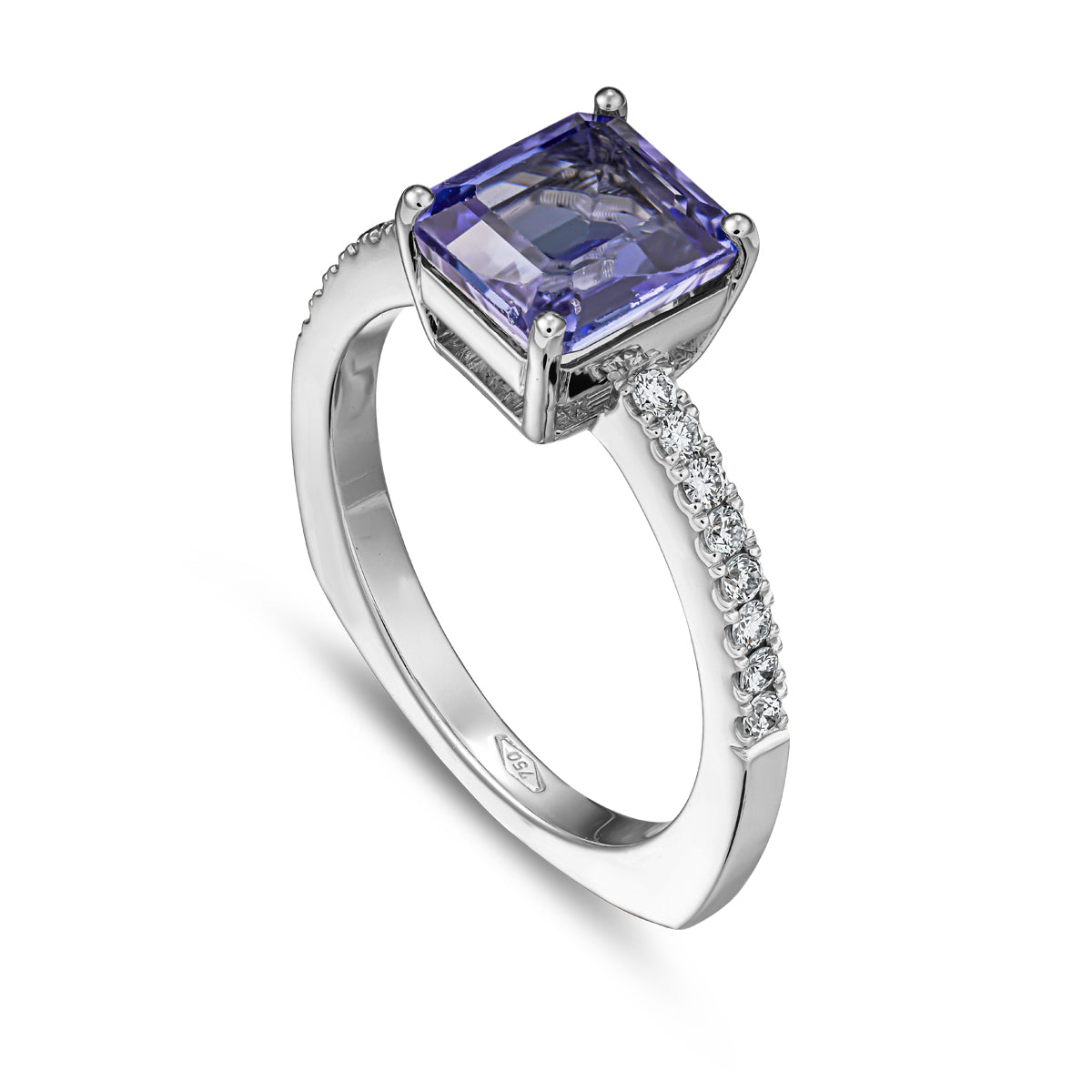 A squarish tanzanite ring with diamonds on the shank, set in white gold designed by carati jewelry in montreal canada in 18 k 14 k