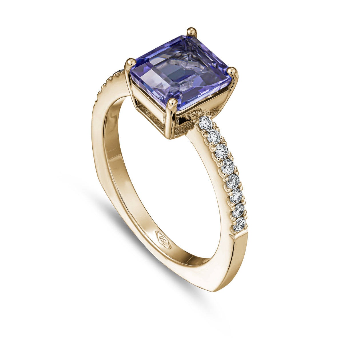 A squarish tanzanite ring with diamonds on the shank, set in white gold designed by carati jewelry in montreal canada in 18 k 14 k