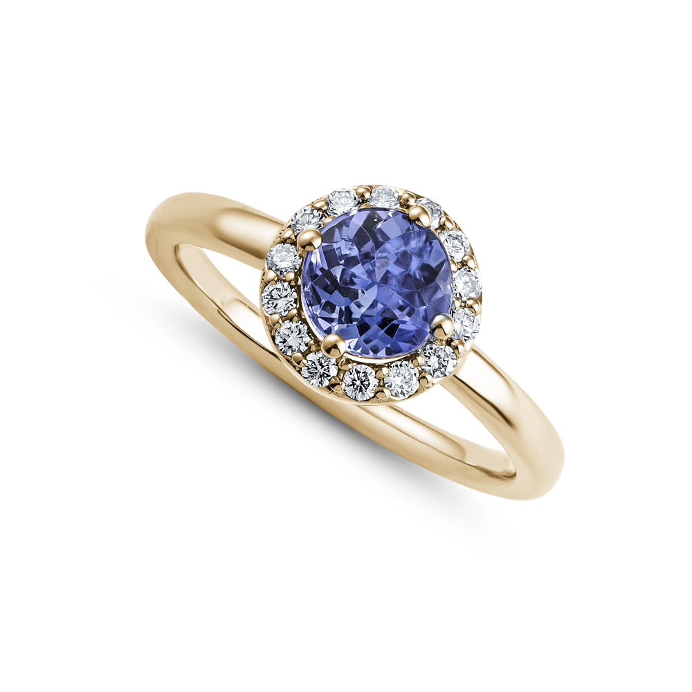 14k and 18 k yellow gold round tanzanite in center with diamond halo aroud it Carati Jewelry Montreal