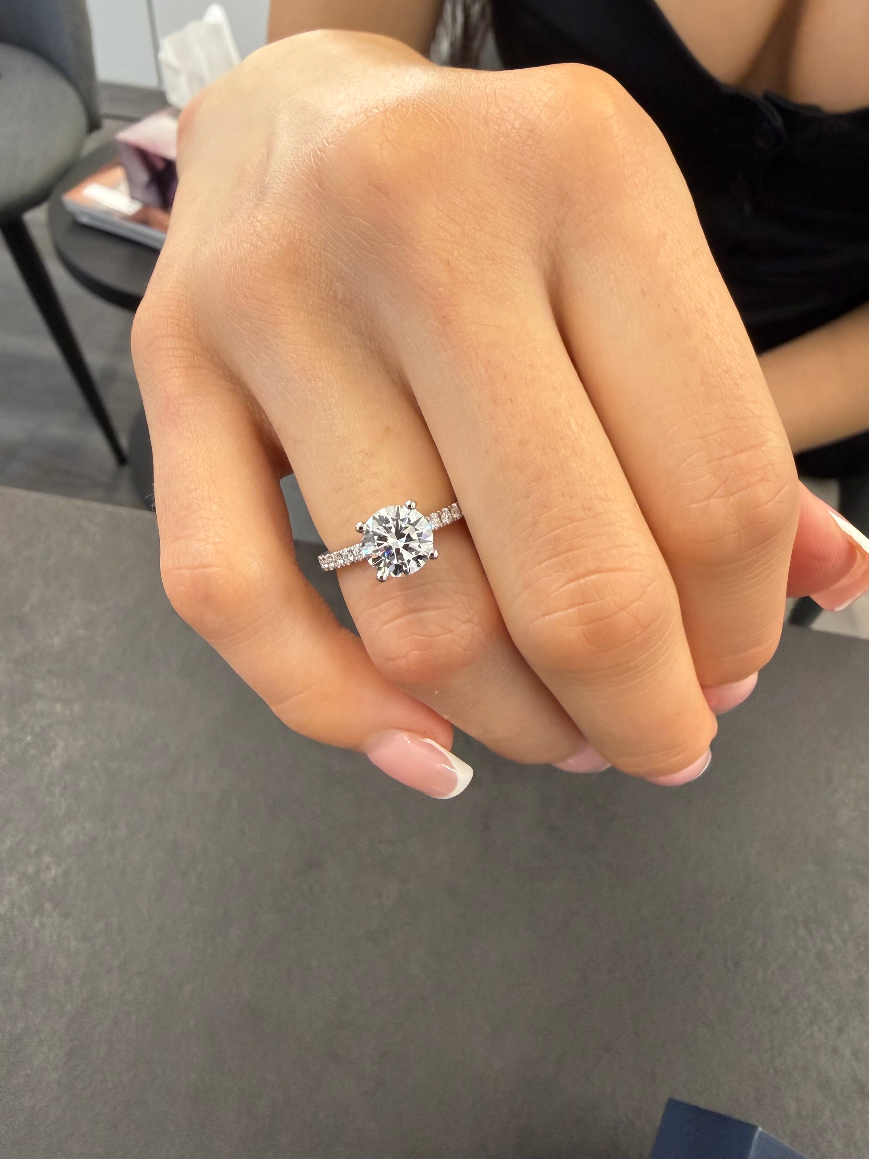 Round Engagement Ring With Diamonds On Both Prongs And Shank